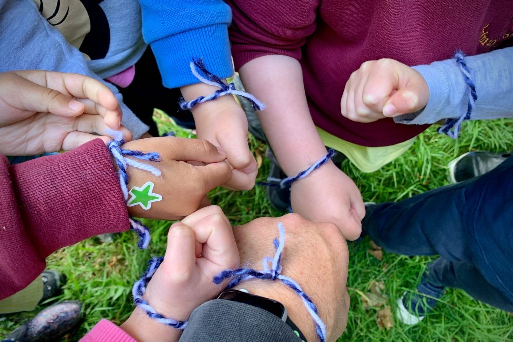 Learners with friendship bracelets on their wrists at Forest Club.