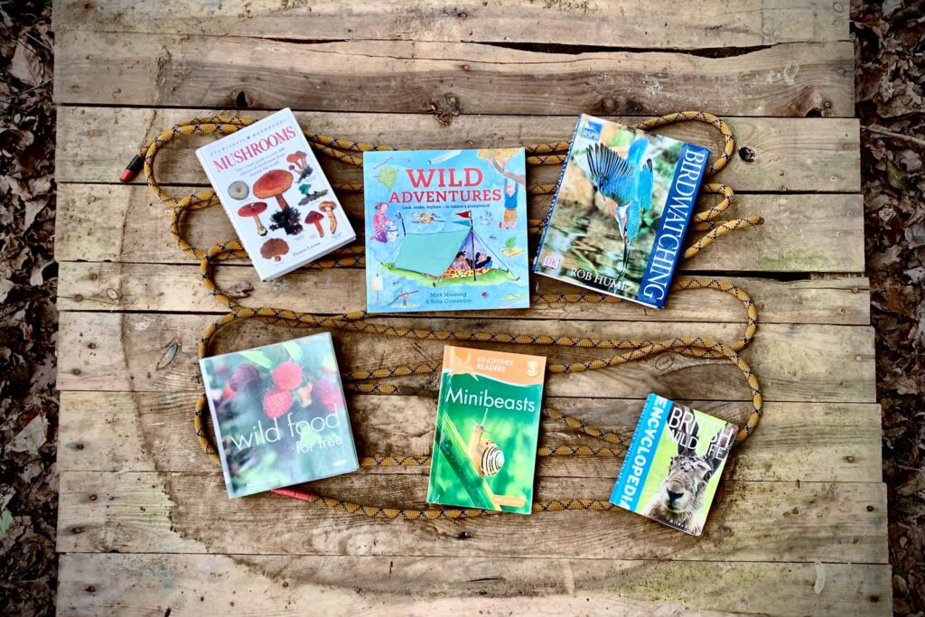 A selection of outdoor focused books set on rope and a pallet.